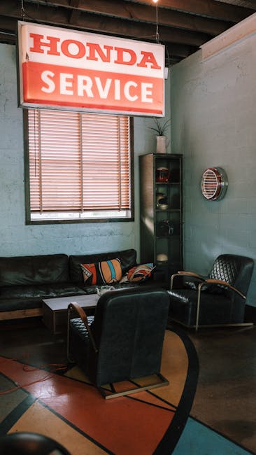 Cozy vintage waiting area in Honda service shop with leather chairs and retro decor. Ideal for automotive themes.