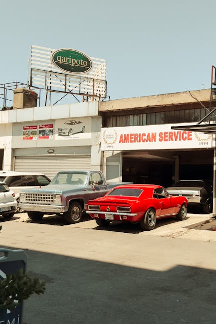 Vintage cars at an urban garage offering American car repair services.